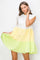 woman wearing a color-blocked short sleeve ruffle hem dress in white, yellow, and lime green