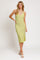 woman wearing a light green knitted midi dress with a v-neckline and side slit