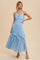 woman wearing a light blue lace maxi dress with ruffle details and spaghetti straps