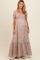 woman wearing a floral maternity maxi dress with short puff sleeves and a tiered hem, showcasing her baby bump