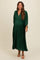 woman wearing a deep green pleated maternity dress with a v-neck and flowing sleeves, showcasing her baby bump