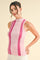 woman wearing a pink ribbed sleeveless top with contrasting stripes and a mock neck