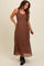 woman wearing a brown maternity maxi dress with a smocked bodice and flowing skirt