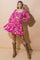 woman wearing a pink floral mini dress with puff sleeves and cowboy boots