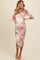 woman wearing a long sleeve pink and green tie-dye maternity dress with ruching details and a fitted silhouette