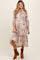 woman wearing a floral patterned maternity dress with a high-low hem and 3/4 sleeves, showing her baby bump