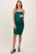 woman wearing a green ruched maternity dress with spaghetti straps and a visible baby bump