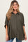woman wearing a dark green checkered maternity shirt with rolled sleeves