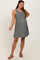 woman wearing a sage green maternity dress with a fitted top and flowing skirt, showcasing her baby bump