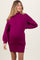 woman wearing a fuchsia ribbed maternity sweater dress with a fitted silhouette and baby bump visible