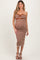 woman wearing a striped brown and white strapless maternity dress with a knotted detail and a visible baby bump