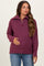woman wearing a burgundy maternity zip-up sweater and gently holding her baby bump