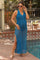 woman wearing a blue maternity maxi dress with a deep v-neck and side slits, highlighting her baby bump