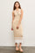 woman wearing a beige ribbed midi dress with button details and white stripe accents on the hem