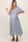woman wearing a white floral print maternity dress with a deep v-neck and short sleeves, showcasing her baby bump