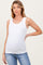 woman wearing a white ribbed maternity tank top and showing her baby bump