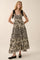 woman wearing a black and white patterned maxi dress with tie straps and a tiered design