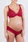 woman wearing a red maternity bra and matching panty, showing her baby bump