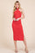 woman wearing a red ribbed halter neck midi dress with a side slit and fitted silhouette