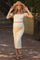 woman wearing a cream off-the-shoulder maternity top and matching midi skirt, showcasing her baby bump, with a straw hat and sandals