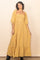 woman wearing a yellow floral maxi dress with puff sleeves and a tiered skirt