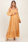 woman wearing a yellow floral off-the-shoulder maternity maxi dress and holding her baby bump
