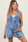 woman wearing a light blue denim maternity romper with tie front detail and visible baby bump