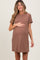 woman wearing a brown short sleeve maternity dress and holding her baby bump