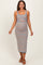 woman wearing a multicolored striped maternity dress with a fitted silhouette and spaghetti straps, showing her baby bump