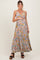 woman wearing a floral maternity maxi dress, showing her baby bump, with a fitted bodice and flowing skirt