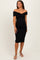 woman wearing a black off-shoulder bodycon maternity dress highlighting her baby bump