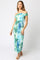 woman wearing a blue and green tie-dye off-shoulder midi dress with a fitted silhouette