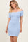 woman wearing a light blue off-the-shoulder bodycon dress with short sleeves and a fitted silhouette