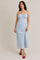 woman wearing a light blue floral maxi dress with adjustable straps and gathered bodice