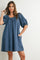 woman wearing a blue short puff sleeve dress with a square neckline and pockets