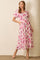 woman wearing a floral pink and white maxi dress with puff sleeves and pockets