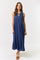 woman wearing a sleeveless navy blue maxi dress with pleated detailing and a tie neckline