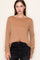woman wearing a camel ribbed long sleeve top paired with black jeans