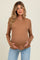 woman wearing a tan ribbed maternity top and holding her baby bump