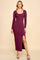 woman wearing a maroon ribbed long sleeve maxi dress with a side slit