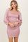 woman wearing a light pink smocked mini dress with puff sleeves and ruffle trim