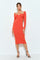 woman wearing a fitted orange ribbed midi dress with long sleeves and a keyhole cutout detail