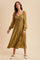 woman wearing an olive green midi dress with long sheer sleeves and decorative embroidery, posing against a neutral background