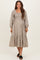 woman wearing a beige checkered maternity dress with puff sleeves and a tiered skirt, showcasing her baby bump