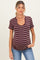 woman wearing a maroon and cream striped maternity top with a scoop neckline and short sleeves, showing her baby bump