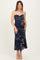 woman wearing a strapless navy blue floral maternity dress and showing her baby bump