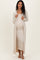 woman wearing a beige ribbed maternity dress with a matching long open cardigan and showing her baby bump