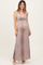 woman wearing a leopard print maternity maxi dress with pink lace trim and showing her baby bump