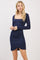 woman wearing a navy blue long sleeve bodycon dress with a square neckline and side ruching detail