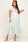 woman wearing a light blue and white striped maternity dress with puff sleeves and a tiered hem, showing her baby bump